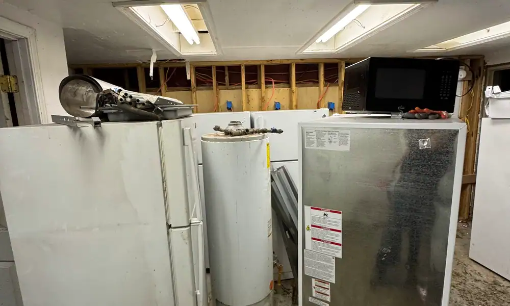 Old refrigerators and a water heater waiting for removal