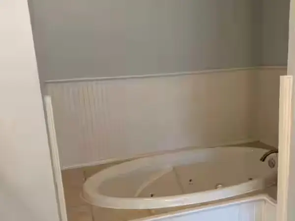 Bathroom with its tub, tile and fixtures in place