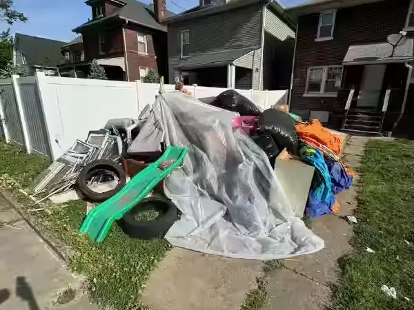 Household junk piled beside a walk