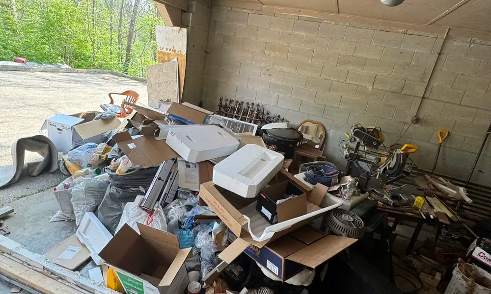 Garage bay filled with construction and renovation debris