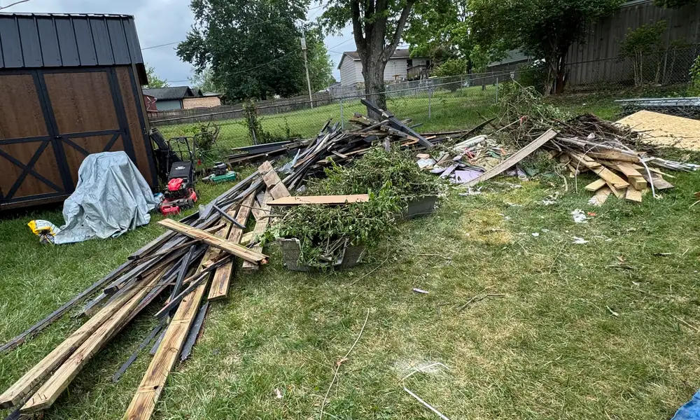 Torn-out deck boards piled on a lawn