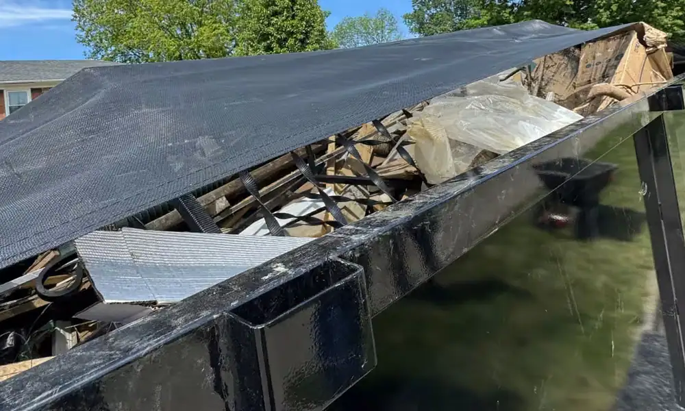 Shed roof and debris loaded into a dump trailer