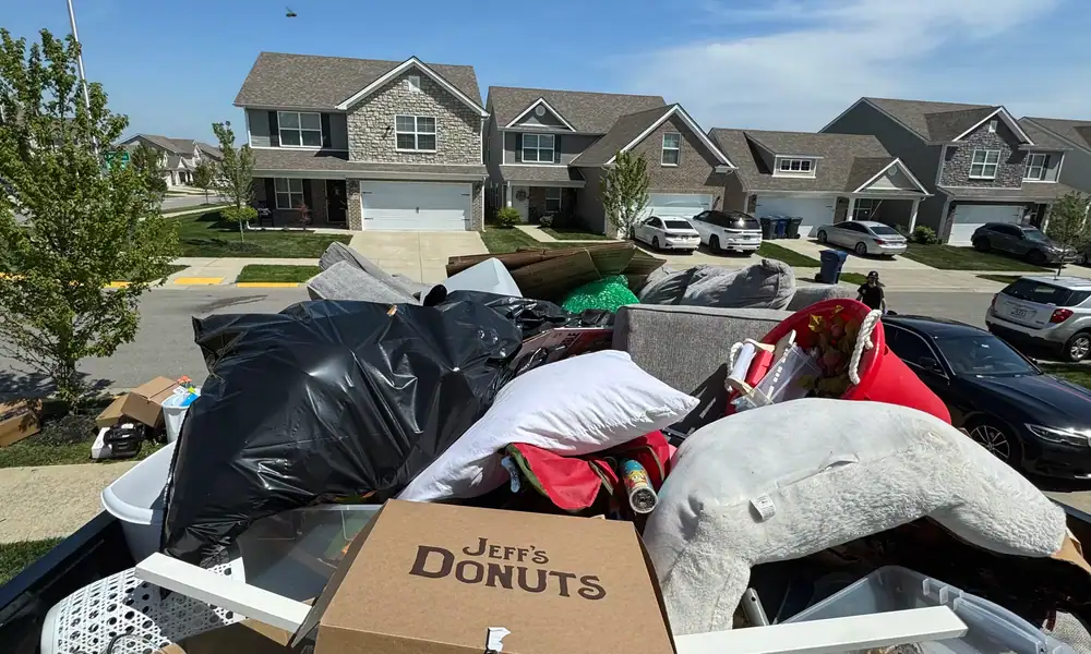 Dump trailer loaded with bags and household items