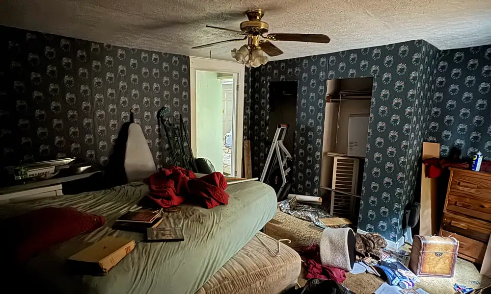 Cluttered bedroom before a cleanout