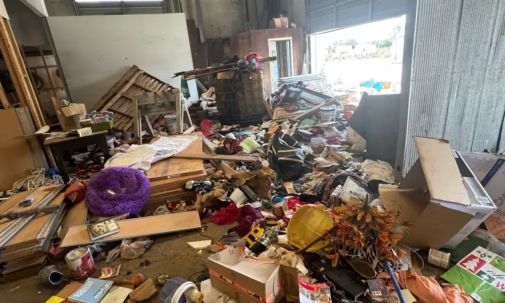 Room piled with junk, boxes and furniture
