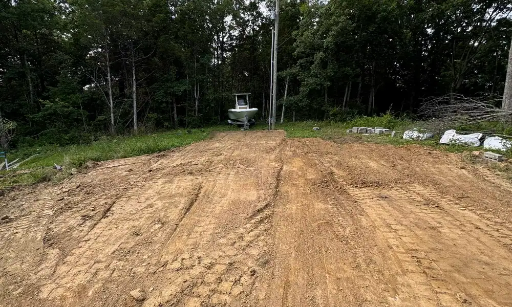 Cleared strip of bare ground running toward a tree line