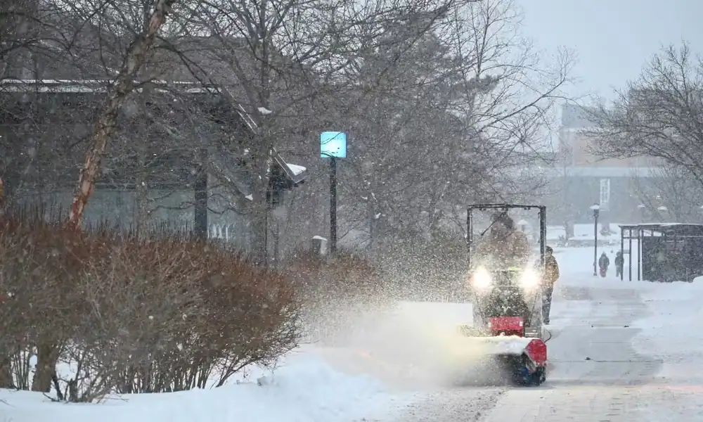 Plow clearing a snow-covered walkway