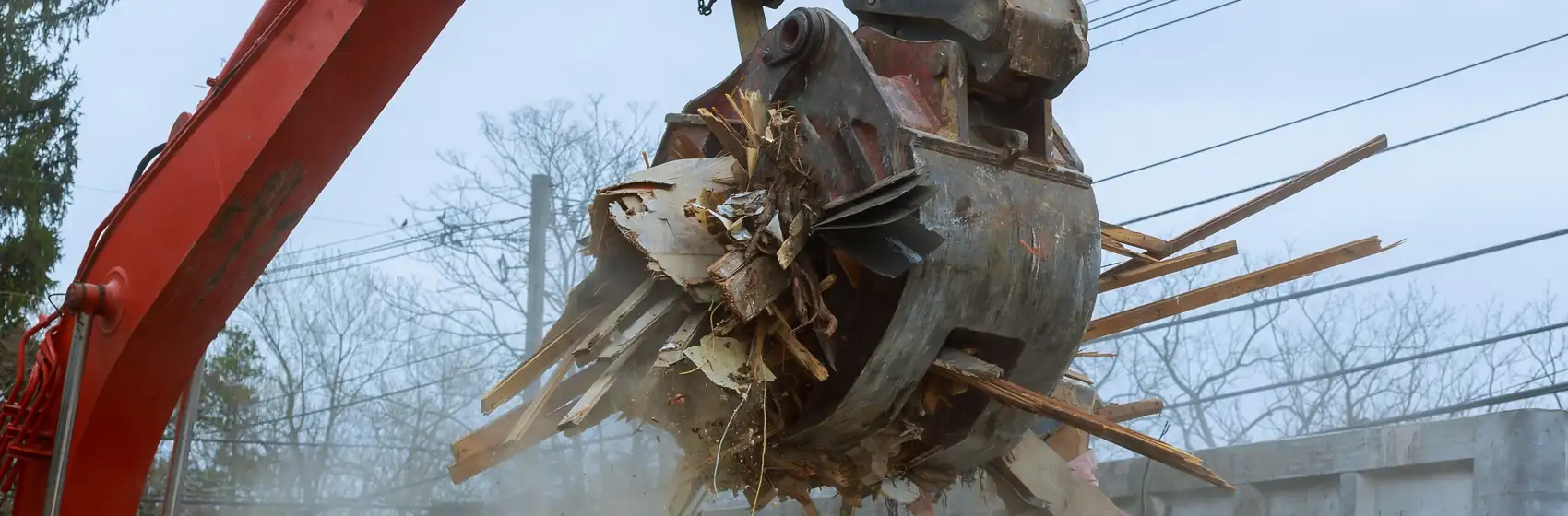 Excavator grapple lifting demolition timber